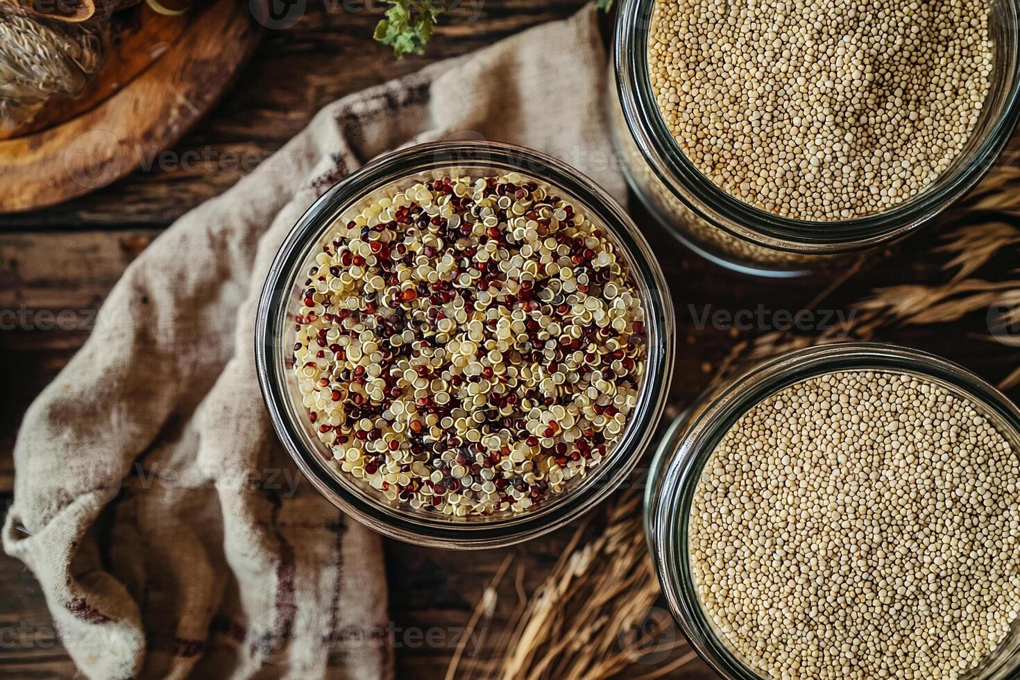 Three jars of quinoa and other grains on a wooden table photo