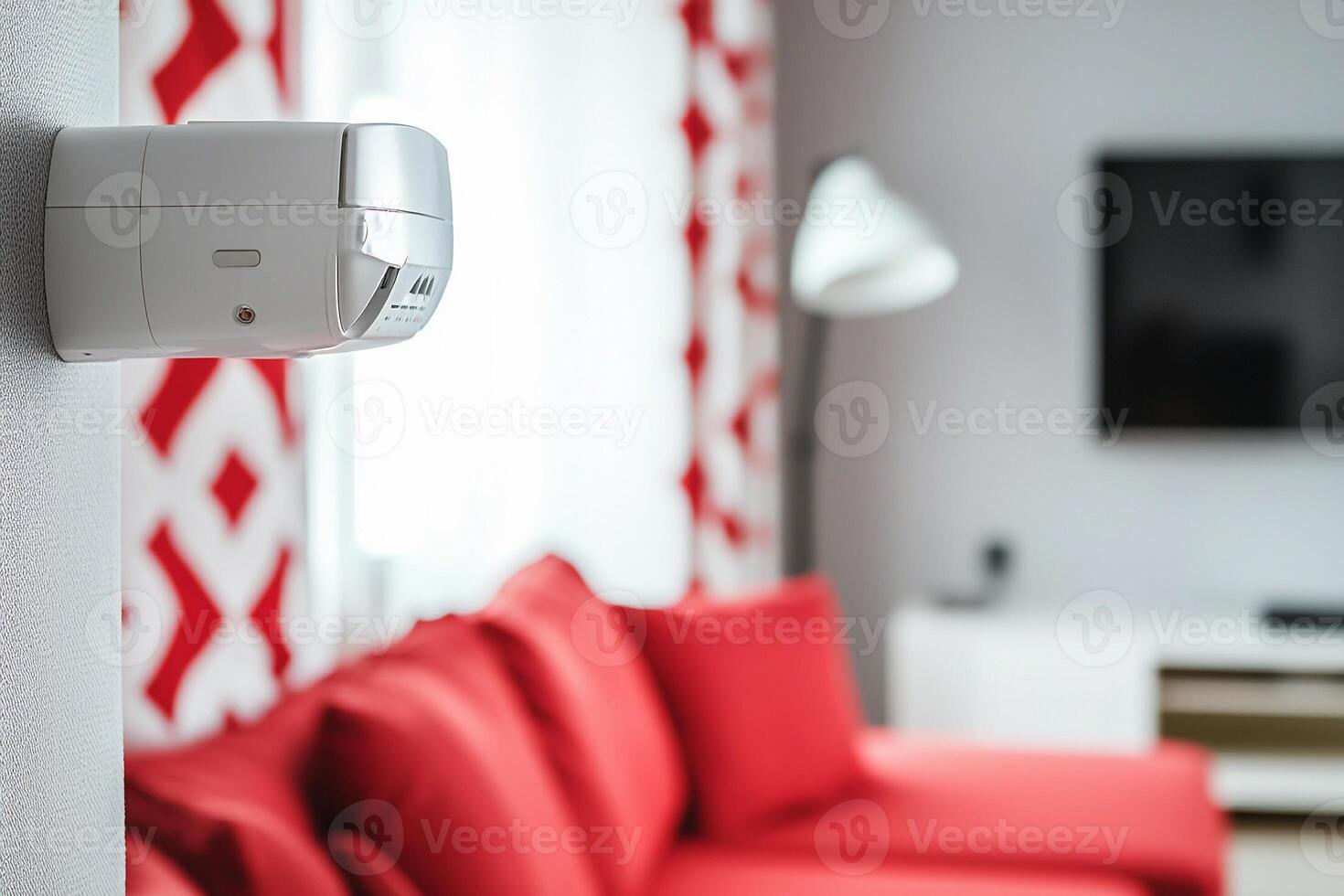 A red couch and a white security camera photo
