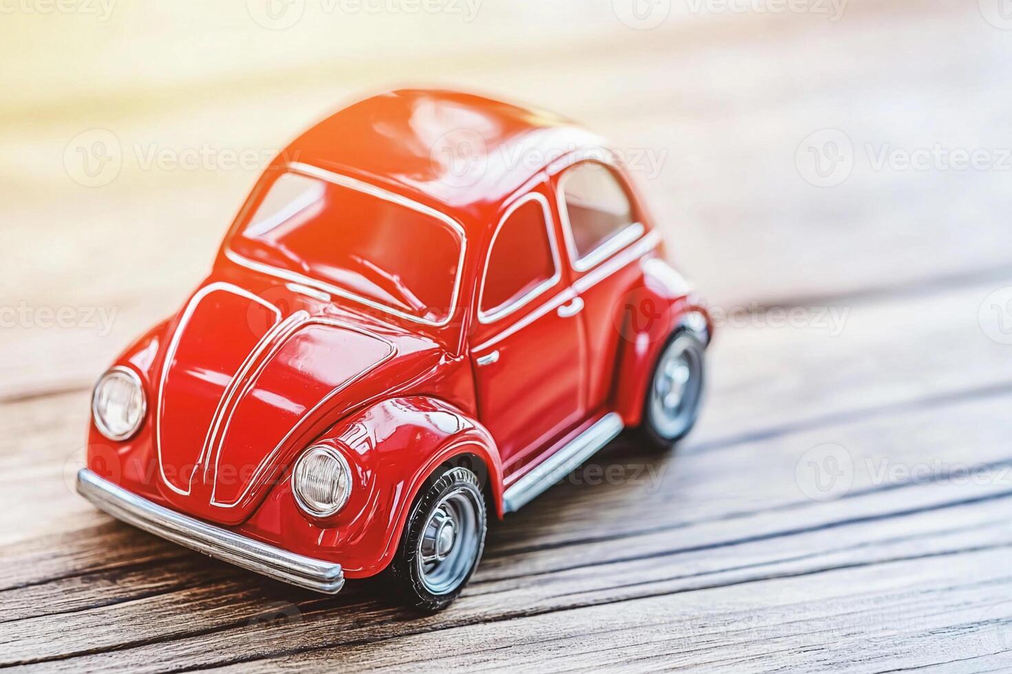 A red toy car on a wooden surface photo