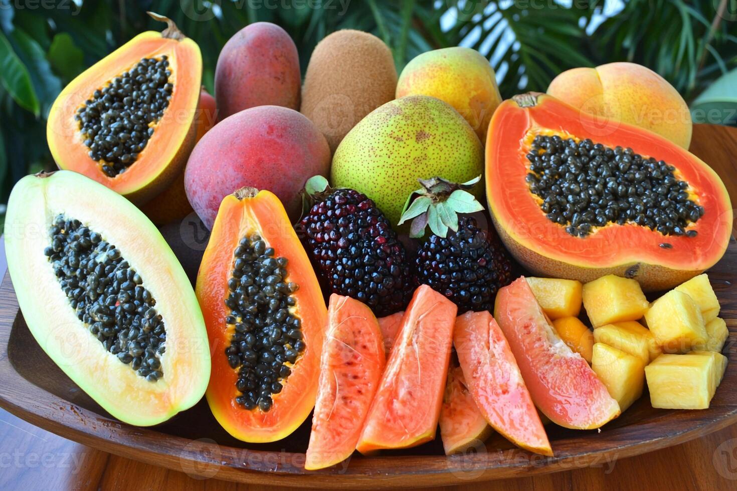 A wooden plate with a variety of fruits on it photo
