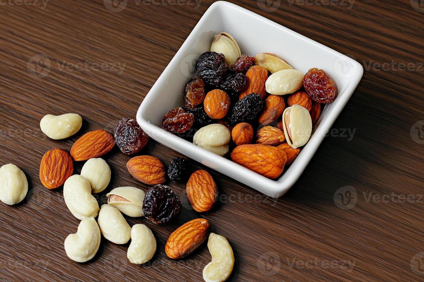 A bowl of mixed nuts and dried fruit photo