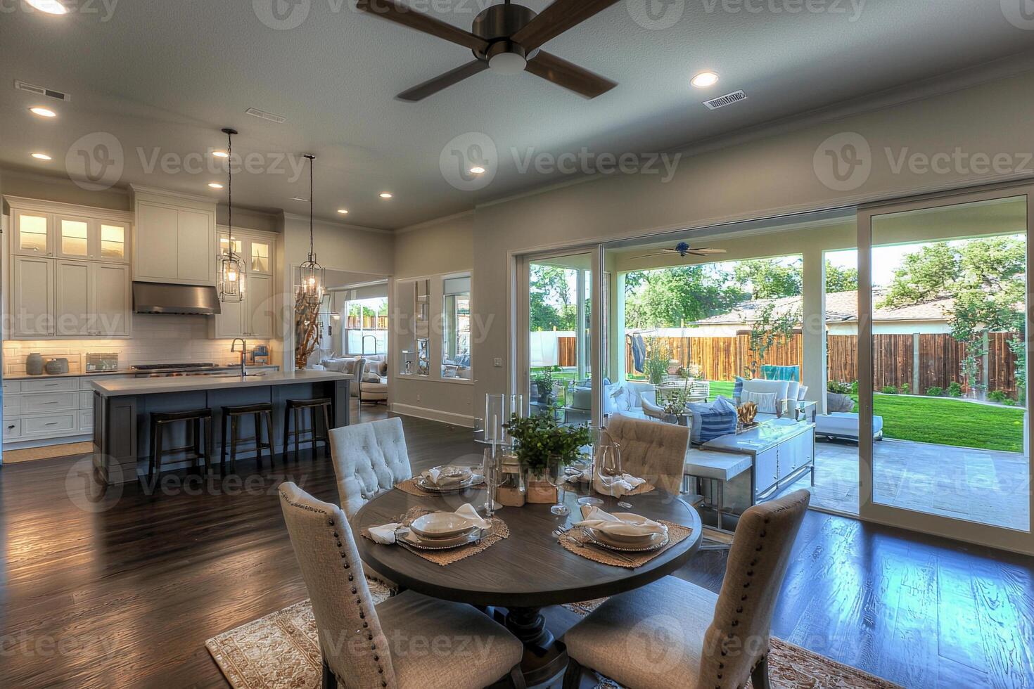 A kitchen and dining room with a ceiling fan photo