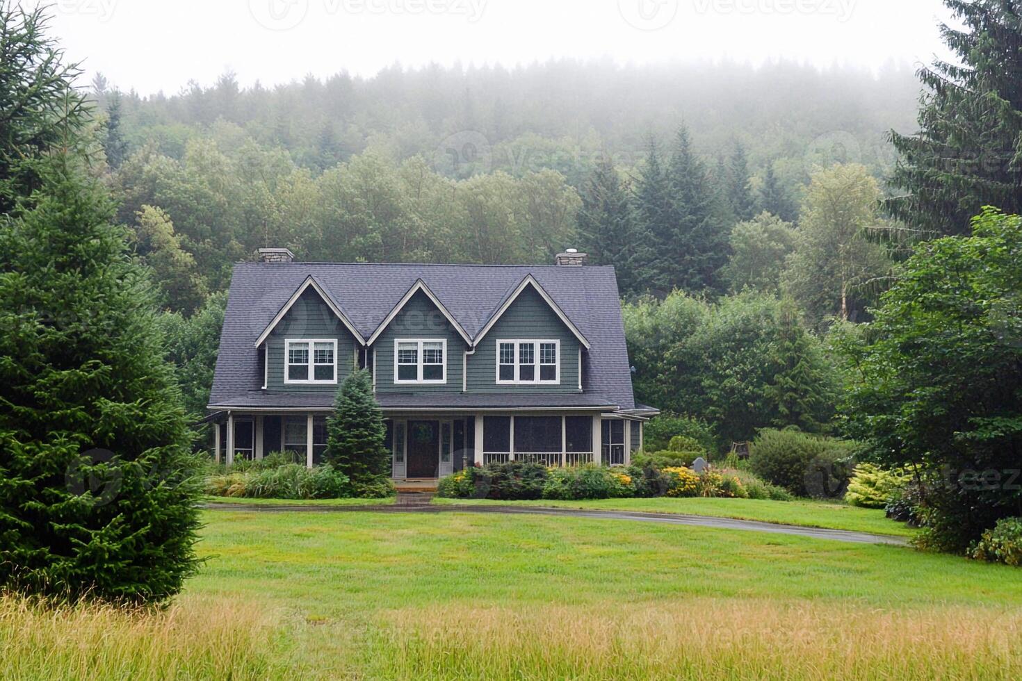 A large house sitting in the middle of a lush green field photo