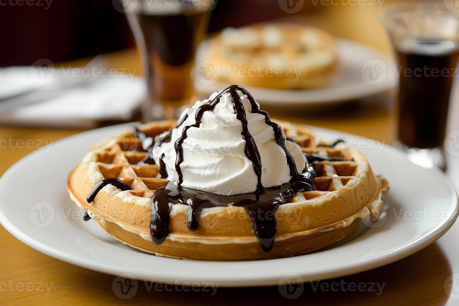 A waffle with whipped cream and chocolate sauce photo