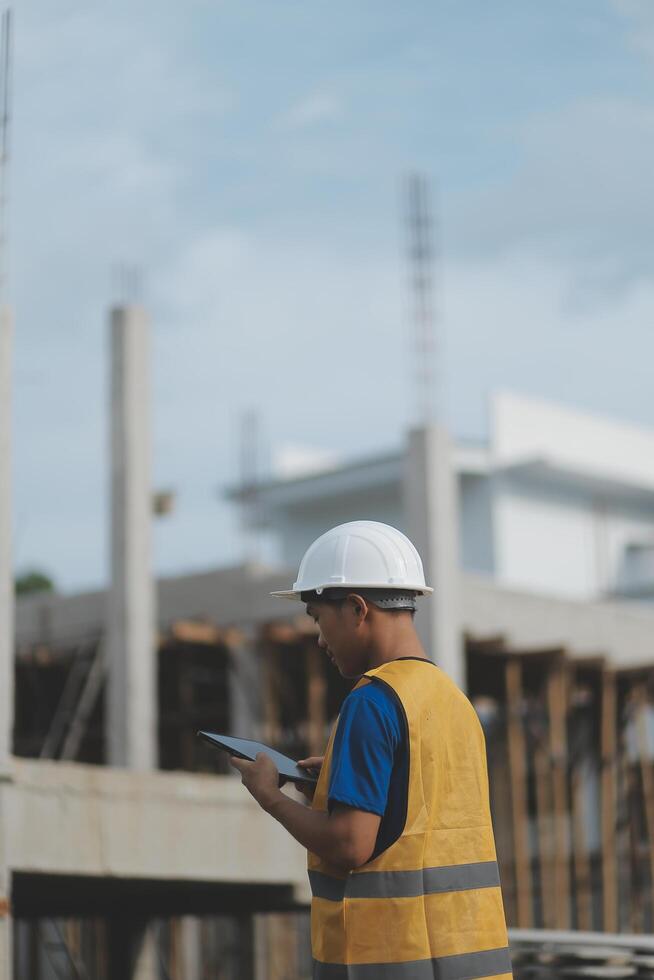 worker inspection while in Left hand hold tablet. inspector engineer using tablet. photo