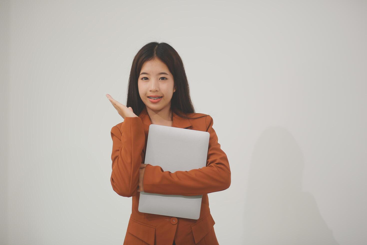 Young beautiful Asian woman in business office standing use tablet in hand, Thai girl enjoy browsing for online shopping store with copy space for advertisement, on isolated white background photo