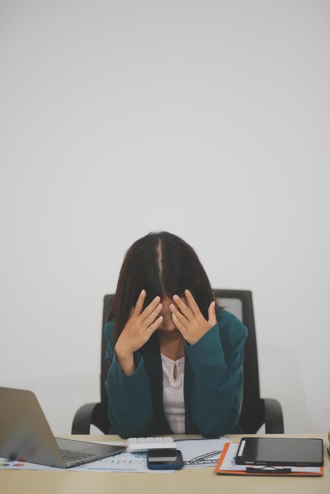 Stressed female worker and business woman holding a pile of paperwork while getting more work to do. Looking frustrated in camera, isolated on white background. Concept Too much work photo