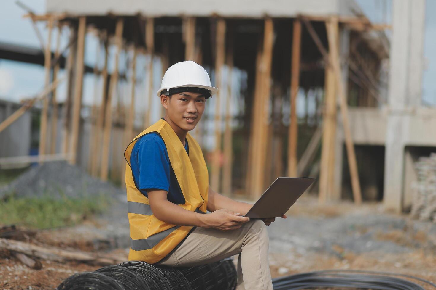 Asian man architect holds blueprint with skyscraper background, Asian male architect builder engineer design working planning confident outdoors in construction site. photo