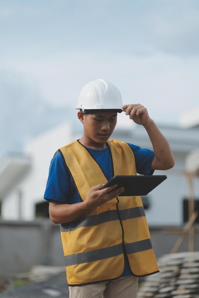 worker inspection while in Left hand hold tablet. inspector engineer using tablet. photo