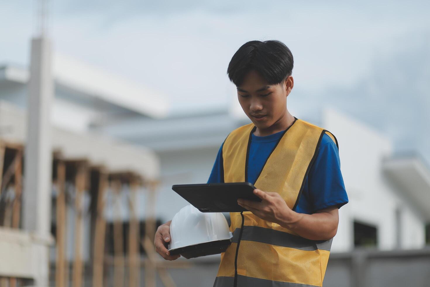worker inspection while in Left hand hold tablet. inspector engineer using tablet. photo