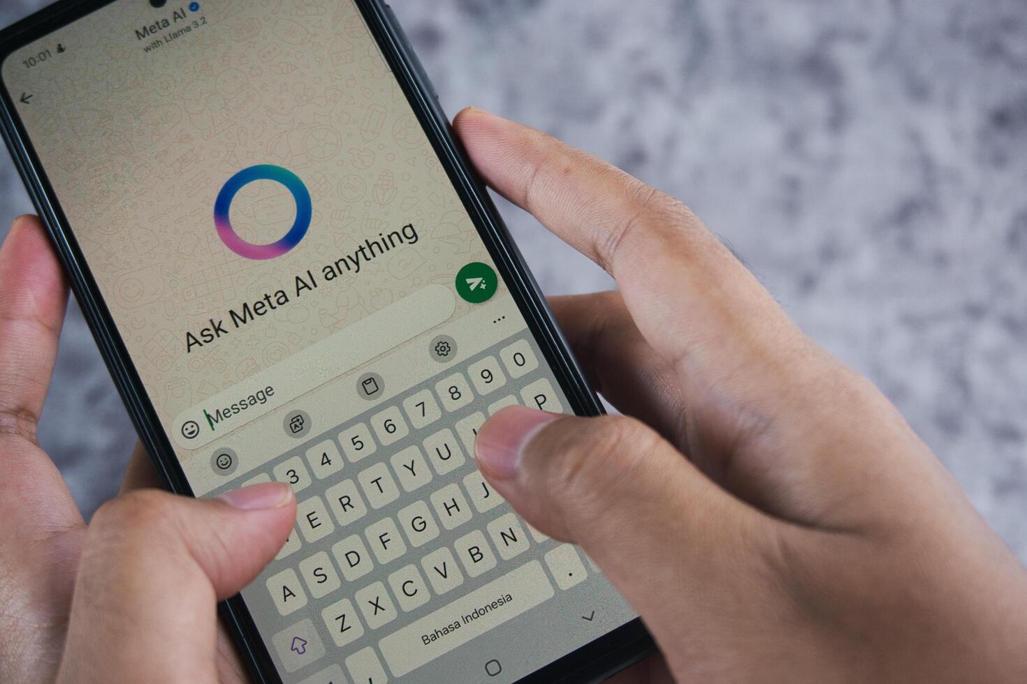 Smartphone Displaying Meta AI Chat Application With User Typing on the Keyboard photo