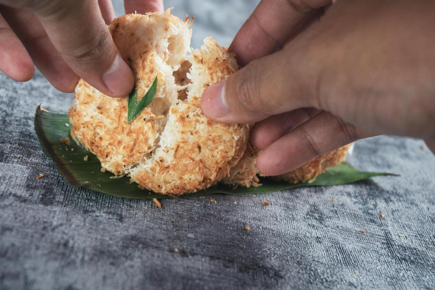 Indonesian Traditional Coconut Cake called Sagon on Banana Leaf with Rustic Background Setting photo