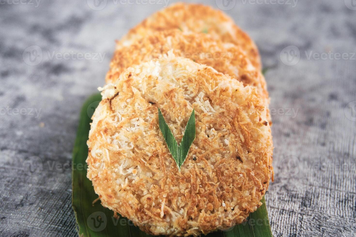 Indonesian Traditional Coconut Cake called Sagon on Banana Leaf with Rustic Background Setting photo