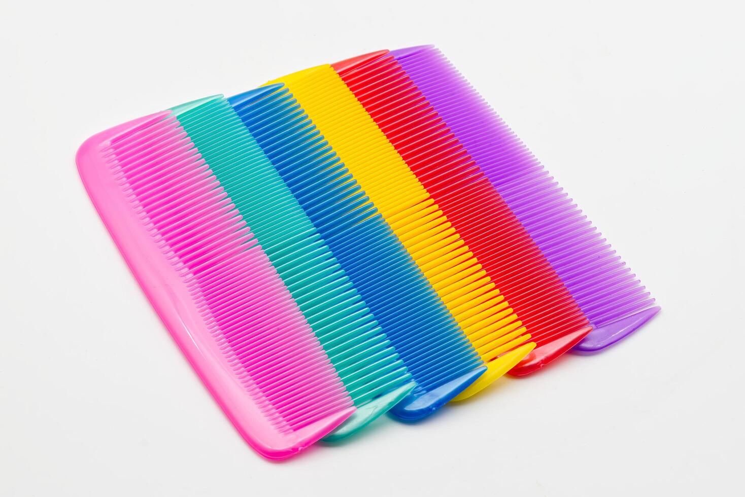 Colorful combs arranged on a white background. photo