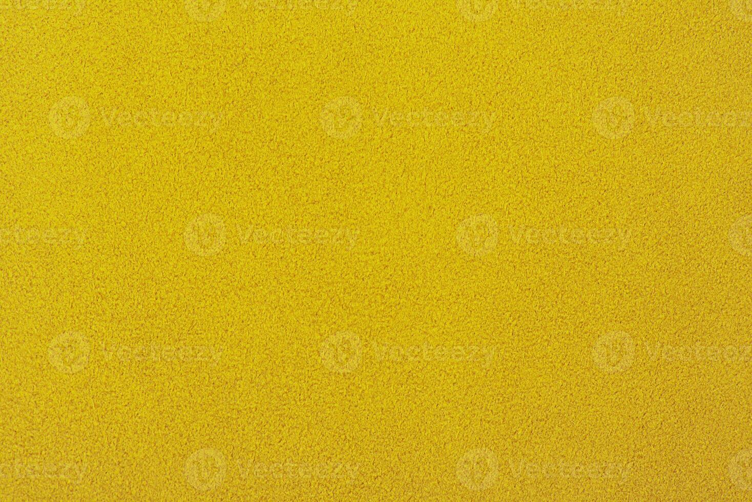 Yellow suede background. Texture of suede leather dyed in light yellow color. photo