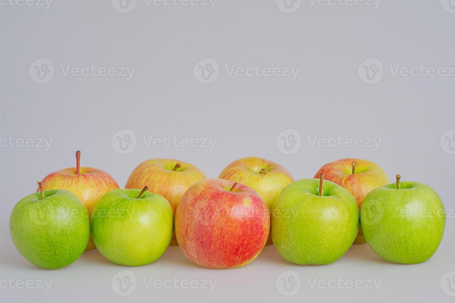 Green and red apples on a gray background. Fruits, apples photo