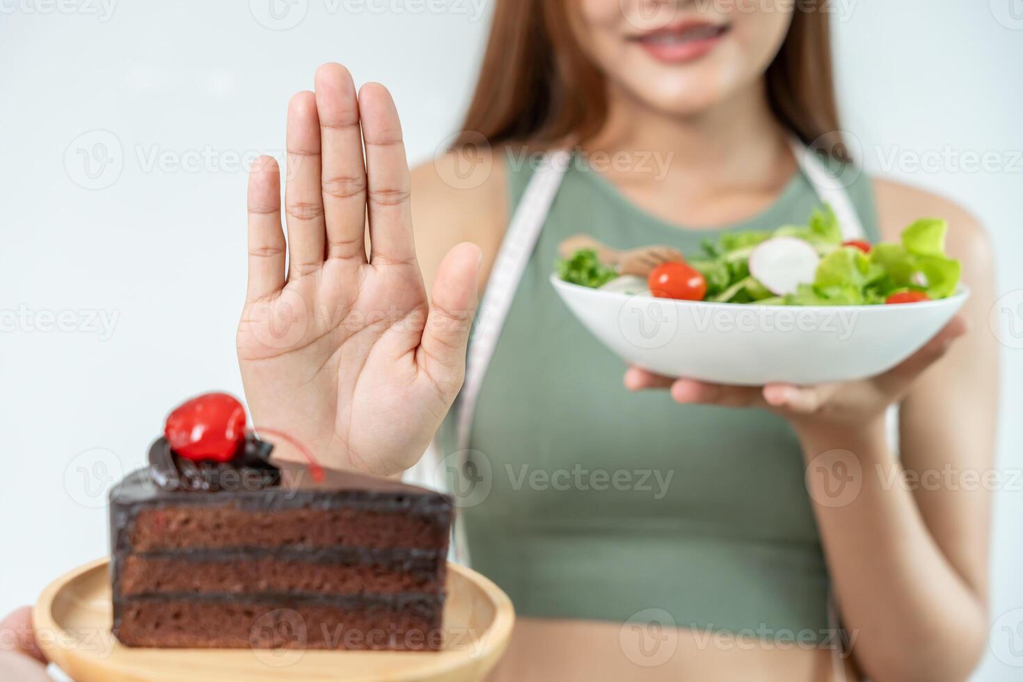 Beauty slim female body confuse chocolate cake. Woman in restaurant achieves weight loss goal for healthy life, crazy about thinness, thin waist, nutritionist. Diet, body shape. photo