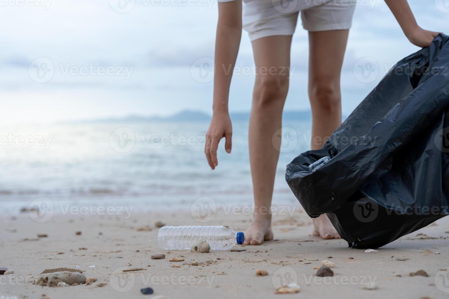 Save water. Volunteer pick up trash garbage at the beach and plastic bottles are difficult decompose prevent harm aquatic life. Earth, Environment, Greening planet, reduce global warming, Save world photo