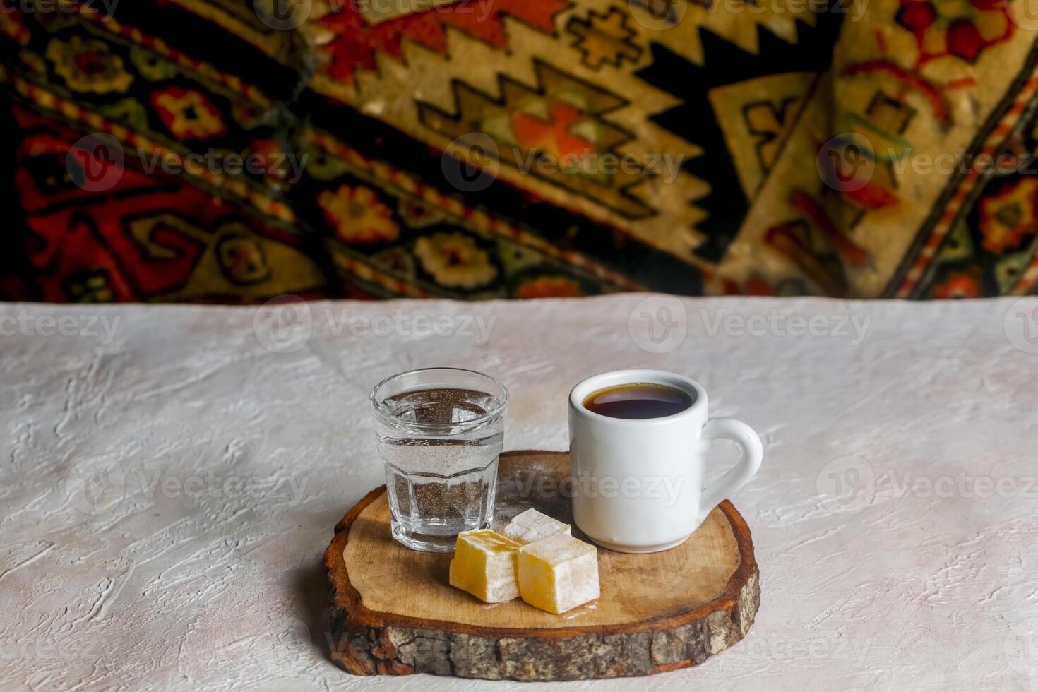 Warm drink and sweets served on a wooden platter with vibrant backdrop photo