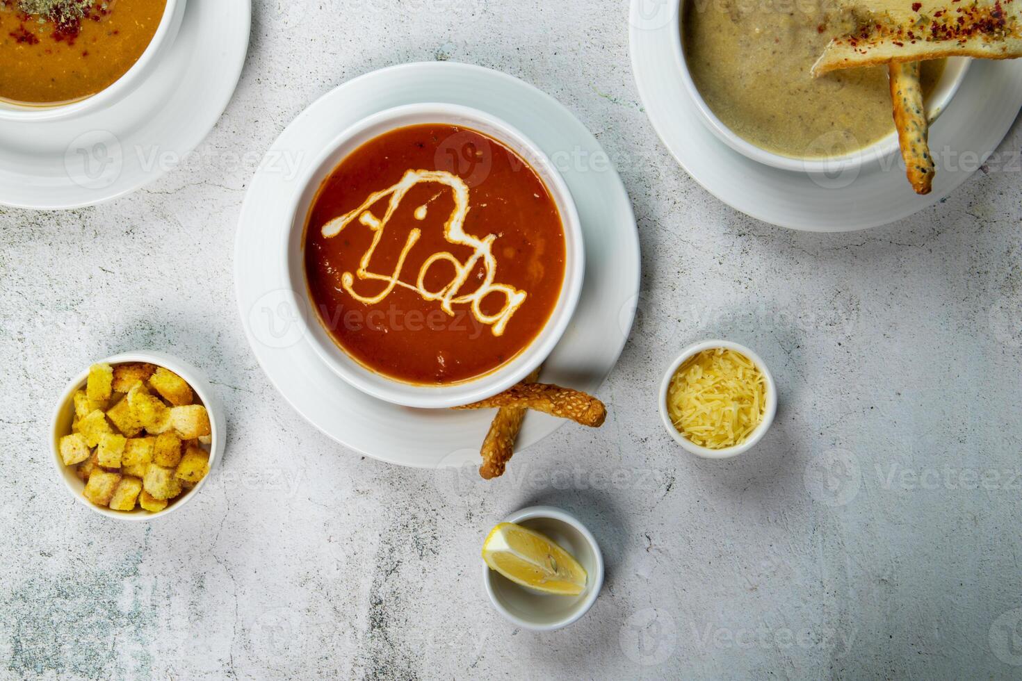 Delicious soup served in elegant bowls with garnishes and sides photo