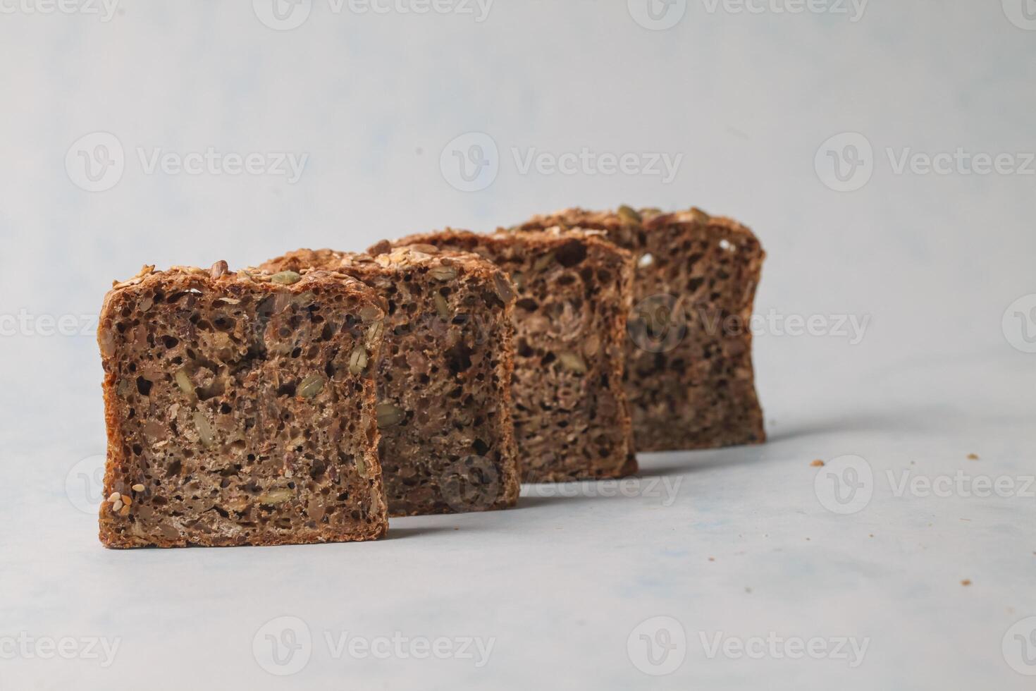 Freshly sliced whole grain bread arranged on a light background photo