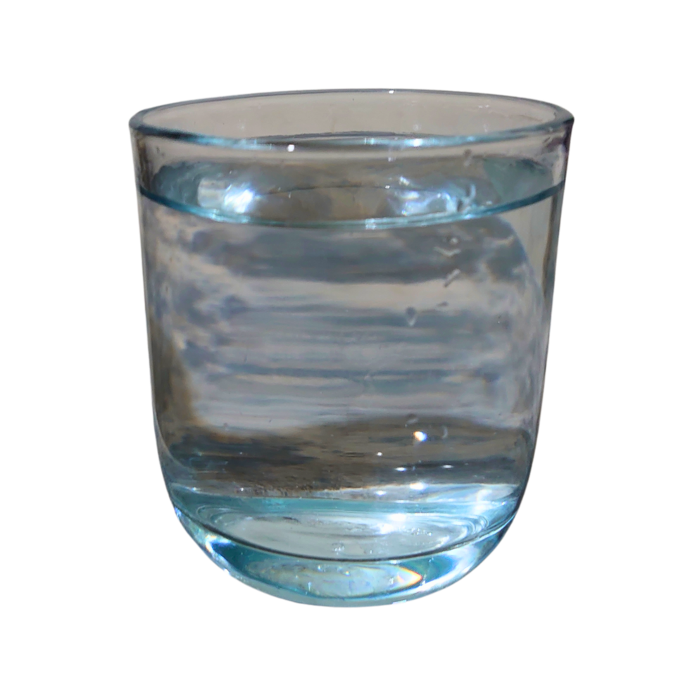 A glass of water with a drop of water in it png
