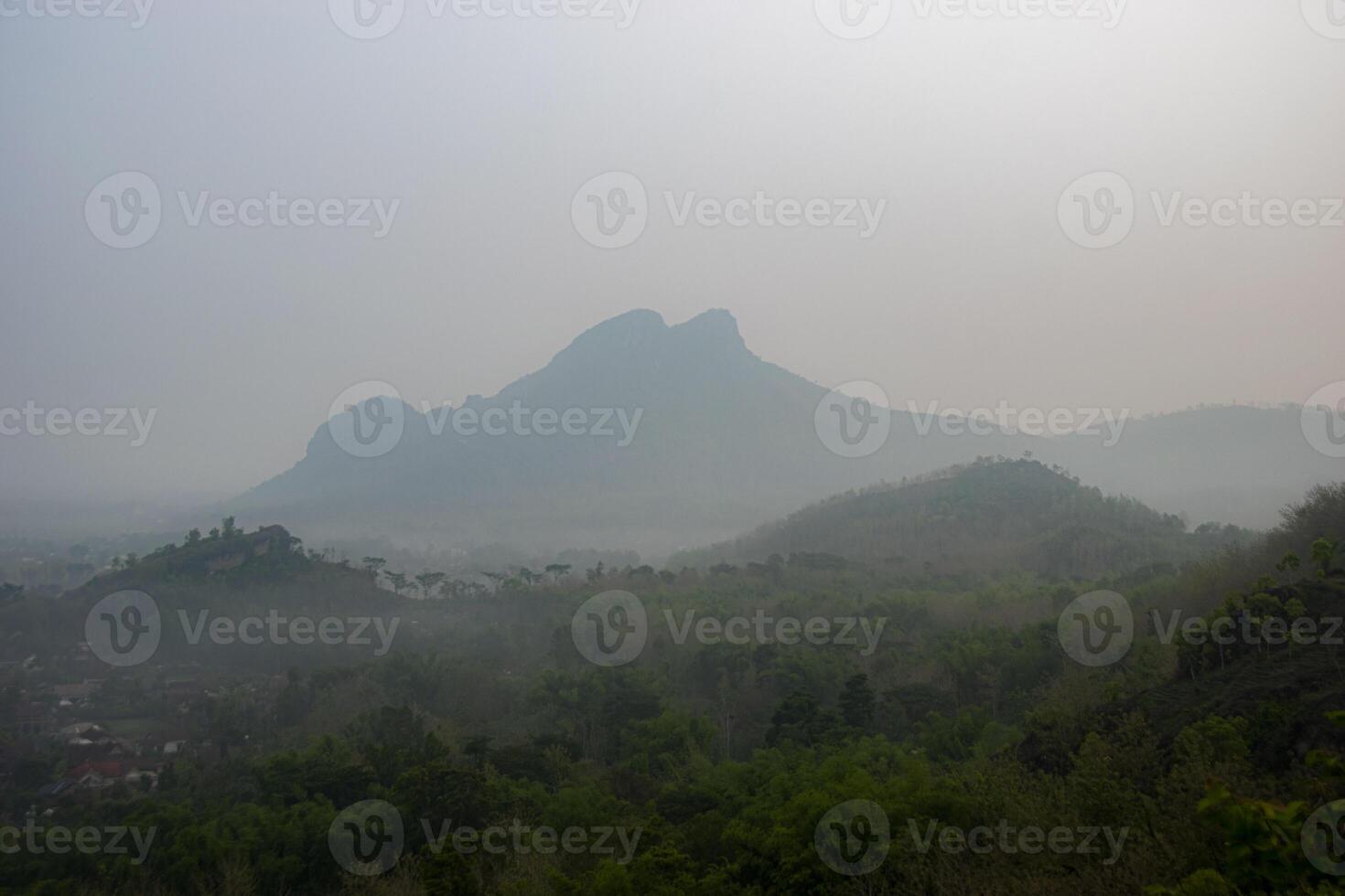 Beautiful view of misty mountain in the morning. Mount Budeg, one of the ancient volcanic geosites located in Tulungagung, East Java, Indonesia photo