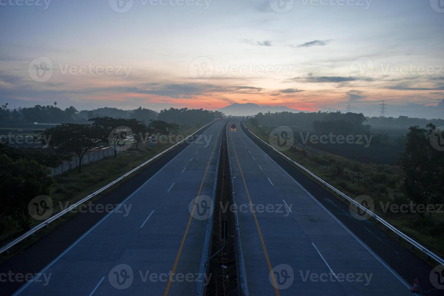 Top view of the highway with a mountain in the background in the morning. photo