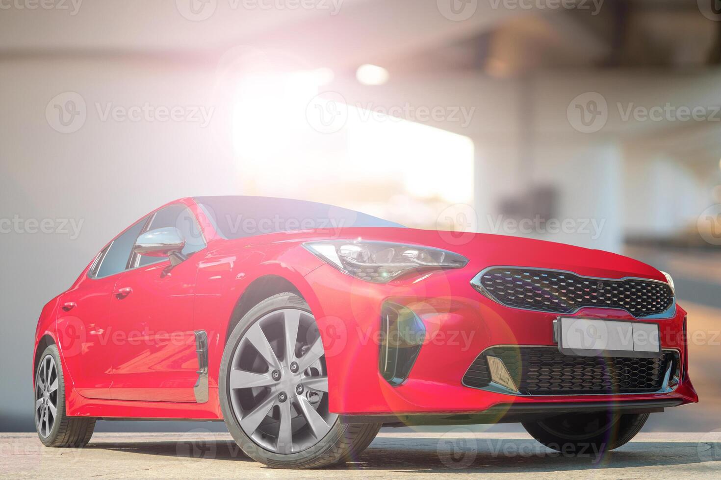 A red car on a background of city environment. Stylish, modern, bright image of the car for design solutions. photo