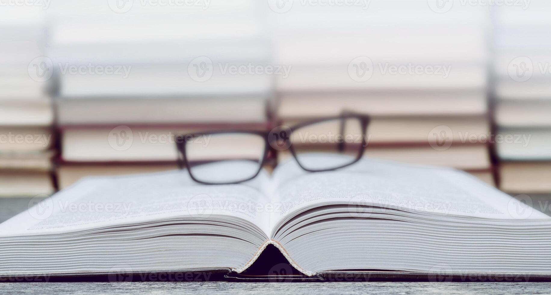 Glasses on the background of books. Symbol of knowledge, science, study, wisdom. photo