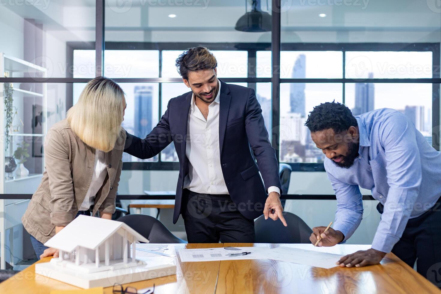 Team of architectures and businessmen discussing and brainstorming on floor plan modification for real estate investment and housing development photo