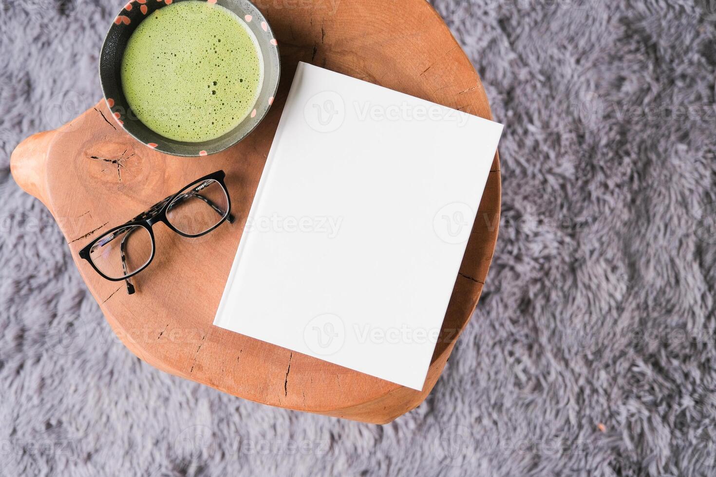 blank book cover mockup on coffee table with green matcha tea photo