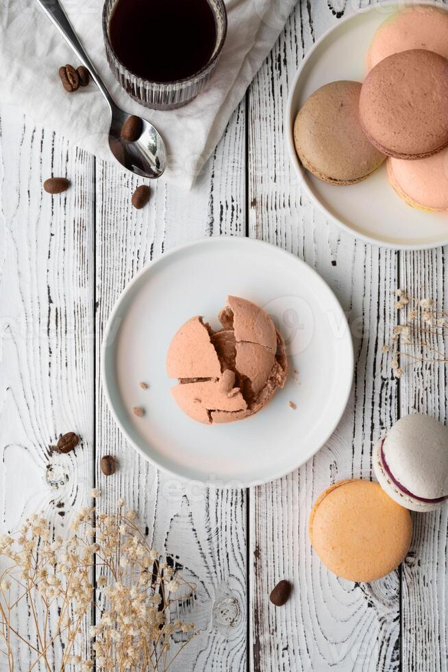 Mocha Mousse - color of the year 2025. Flat lay macarons on the wooden table with coffee photo