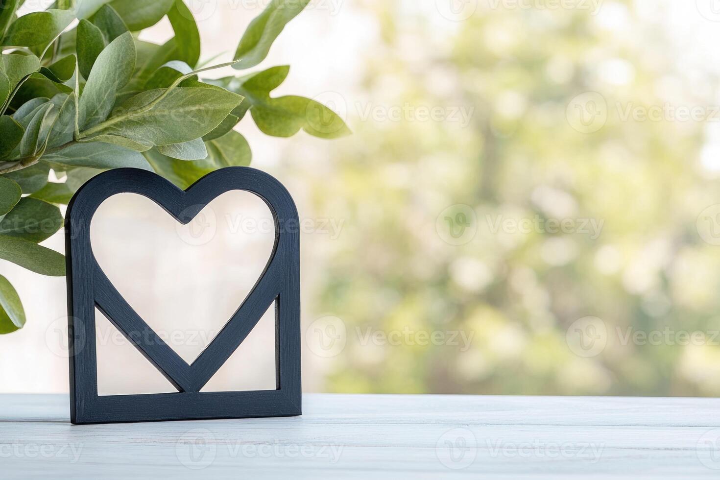 Photo frame of heart shape for mockup design on light table background.