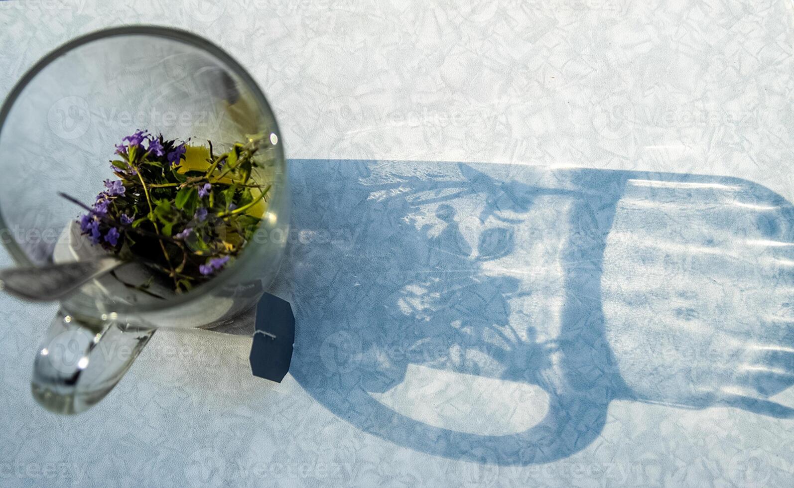 Transparent mug with tea. Brewing tea in bag. Brewing herbal tea. Herbal tea. photo