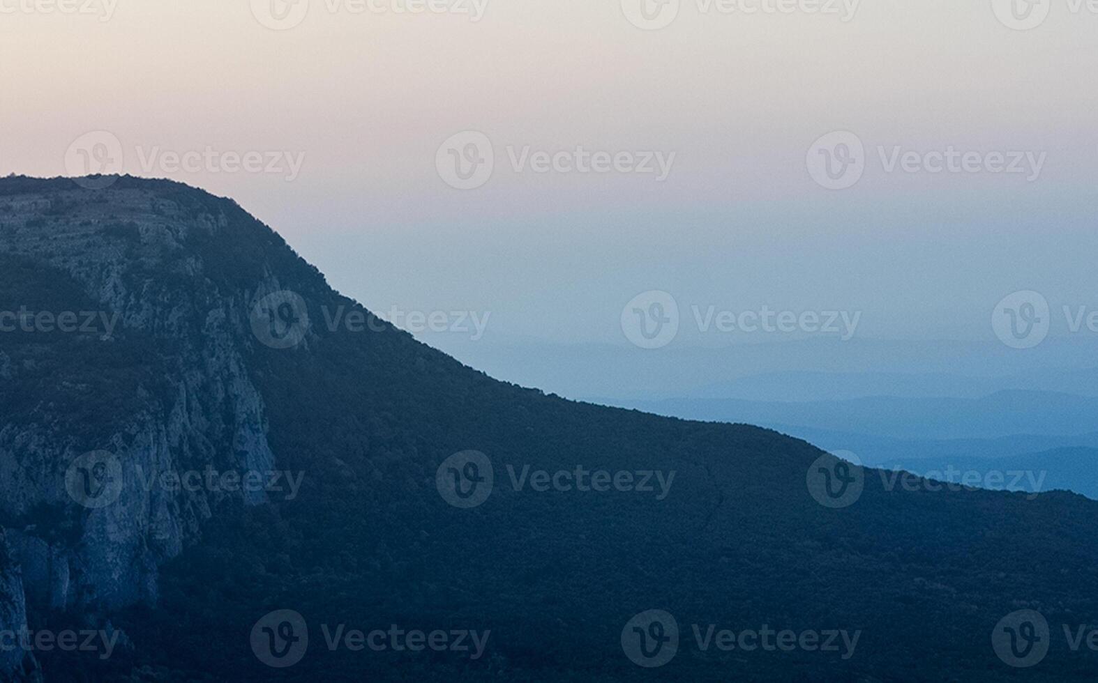 Mountains and forests of Crimea. coniferous and deciduous trees on the hills of mountains and rocks photo