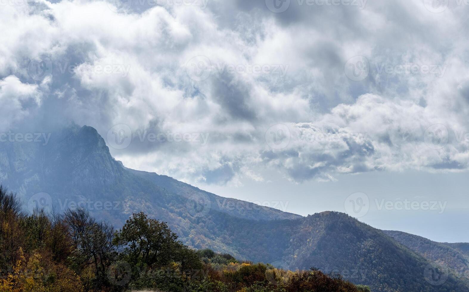 Mountains and forests of Crimea. coniferous and deciduous trees on the hills of mountains and rocks photo