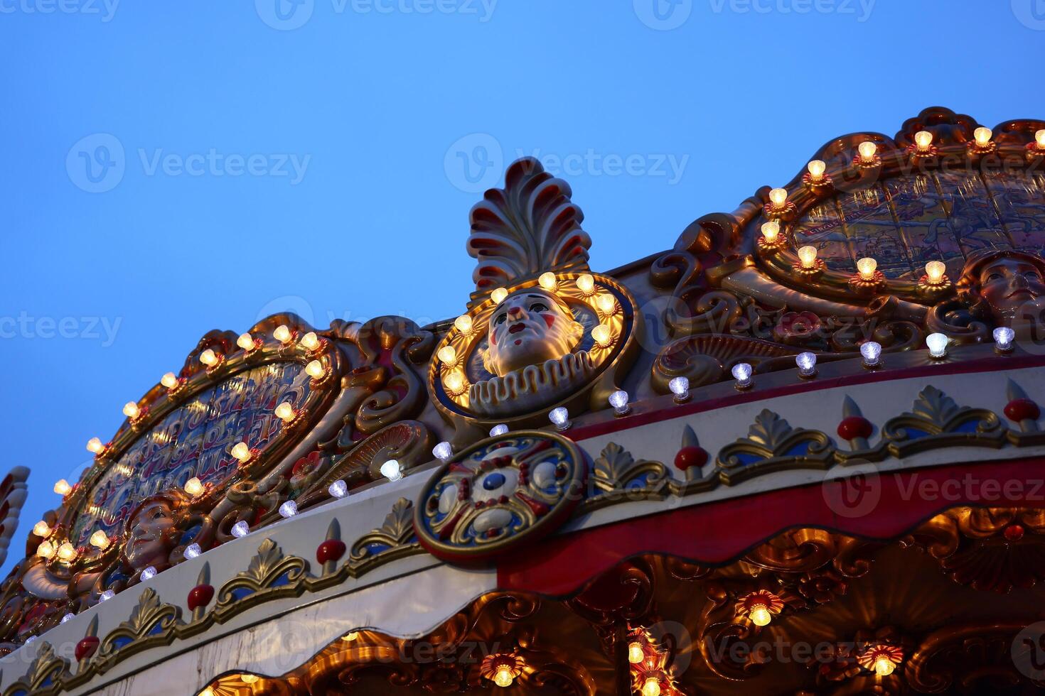 Vibrant and Colorful Carousel Details Set Against a Beautiful Twilight Sky at Dusk photo