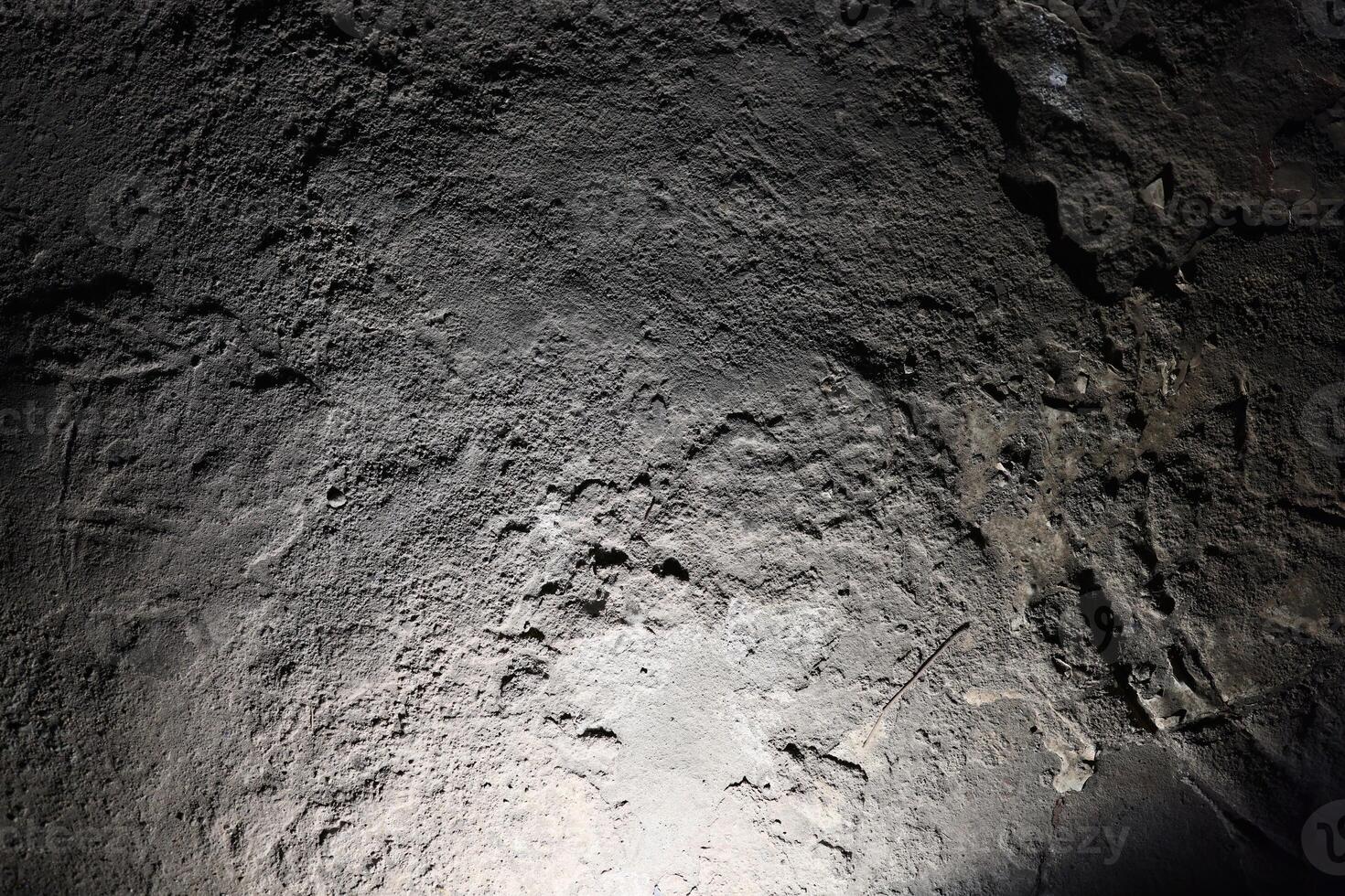 An Intimate CloseUp of a Textured Rock Surface Captured in Low Light Conditions photo