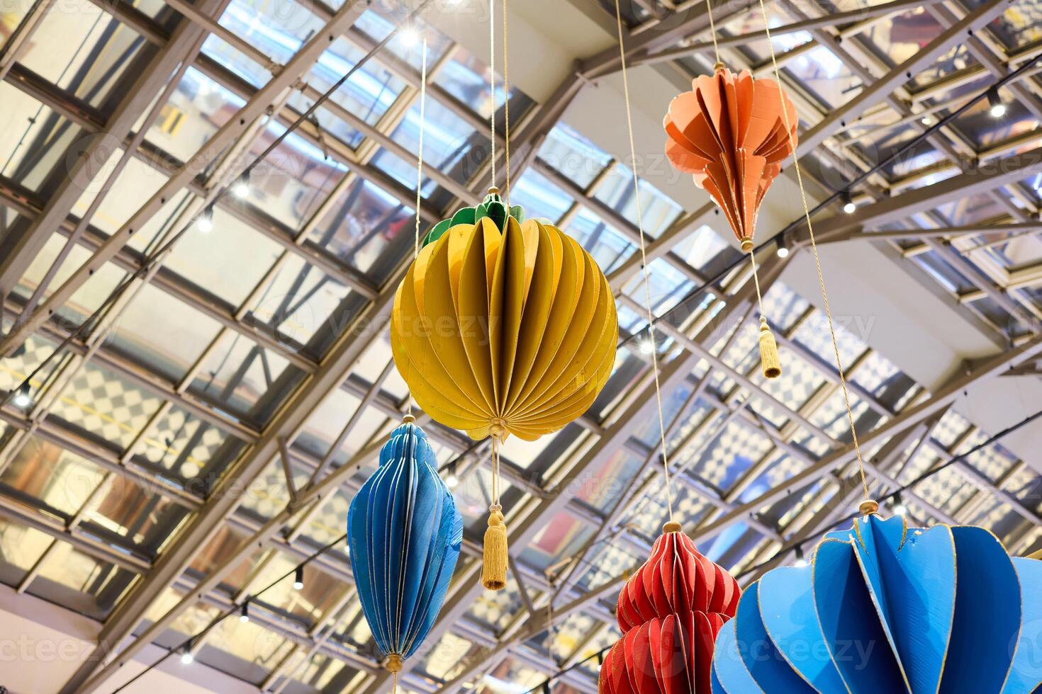 Colorful and Vibrant Hanging Decorations Suspended Beneath a Beautiful Glass Ceiling photo