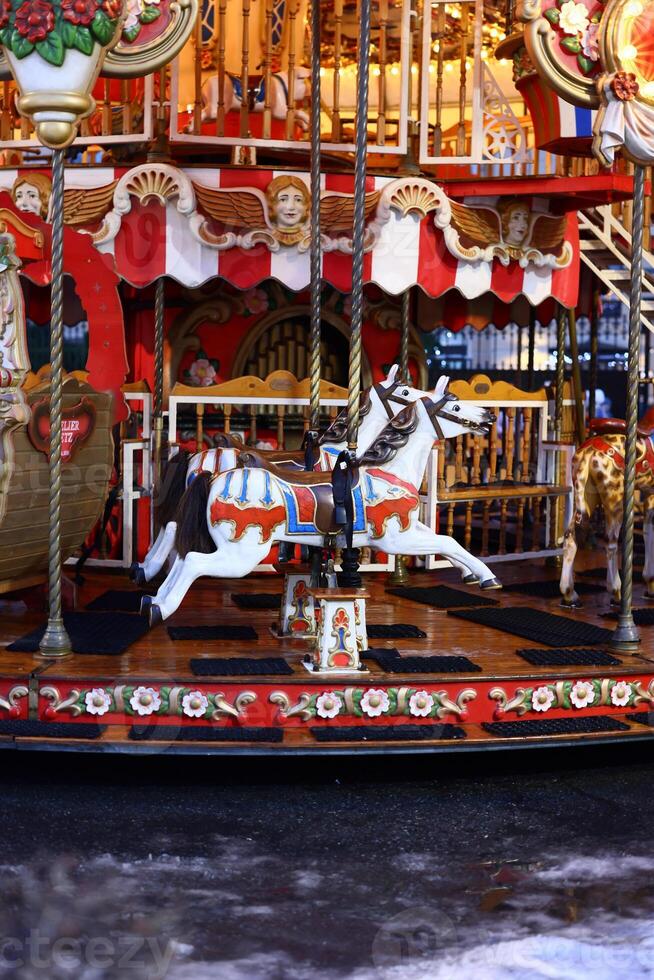 This is a vibrant and colorful Vintage Carousel Horse situated near a picturesque body of water photo