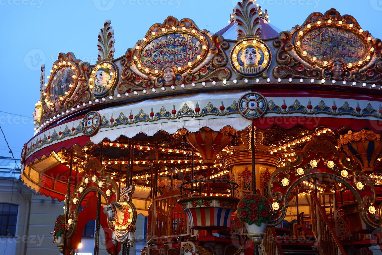 A Colorful Carousel at Dusk, Featuring Elegant Lights and Beautiful Decorations All Around photo