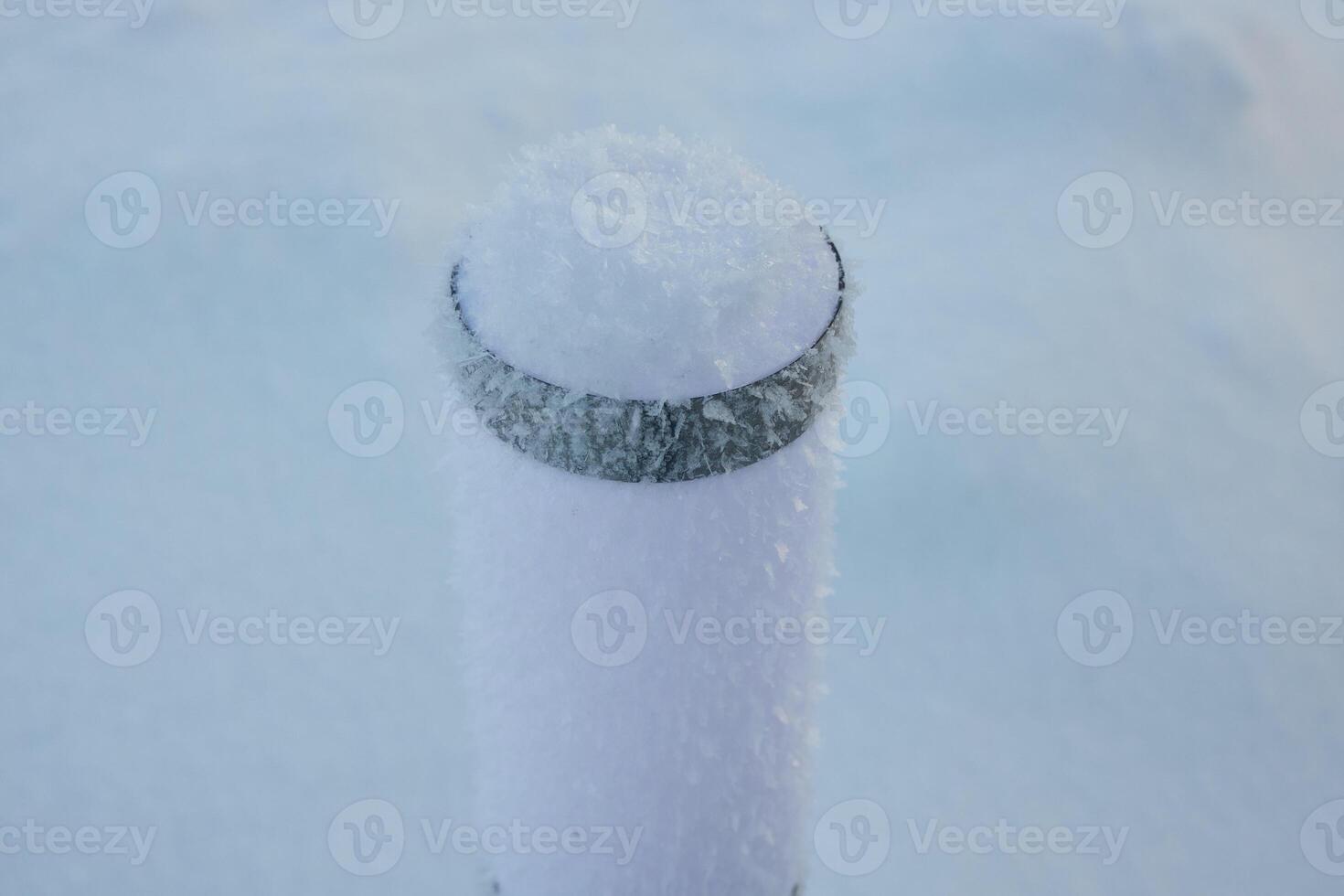 A Majestic SnowCovered Post Standing Proudly in a Beautiful Winter Landscape Scene photo