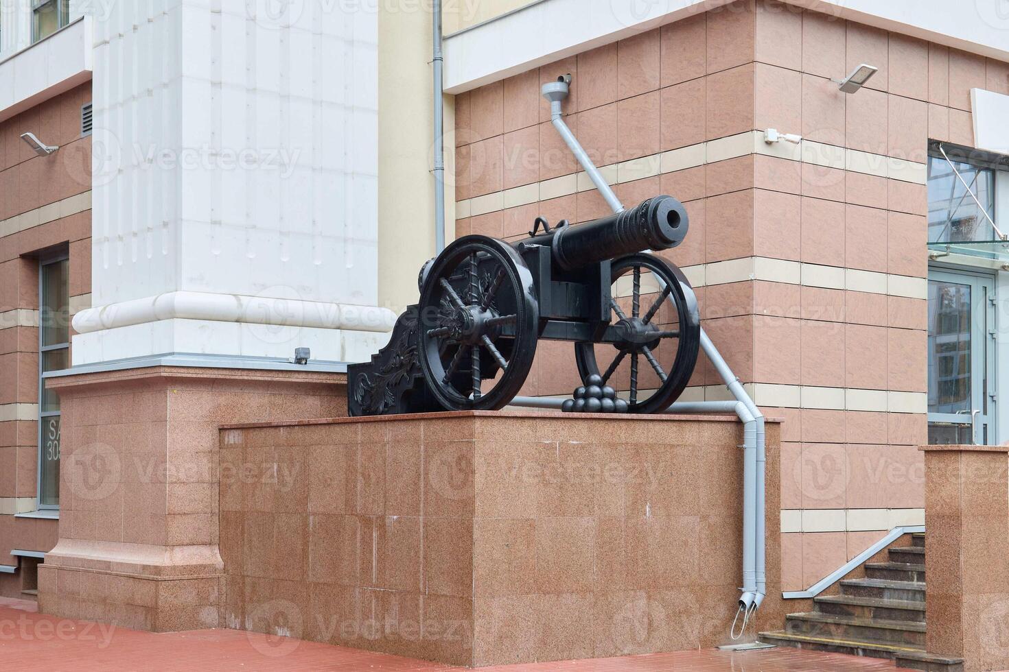 A historic cannon outside a building highlights its importance in commemorating the past photo