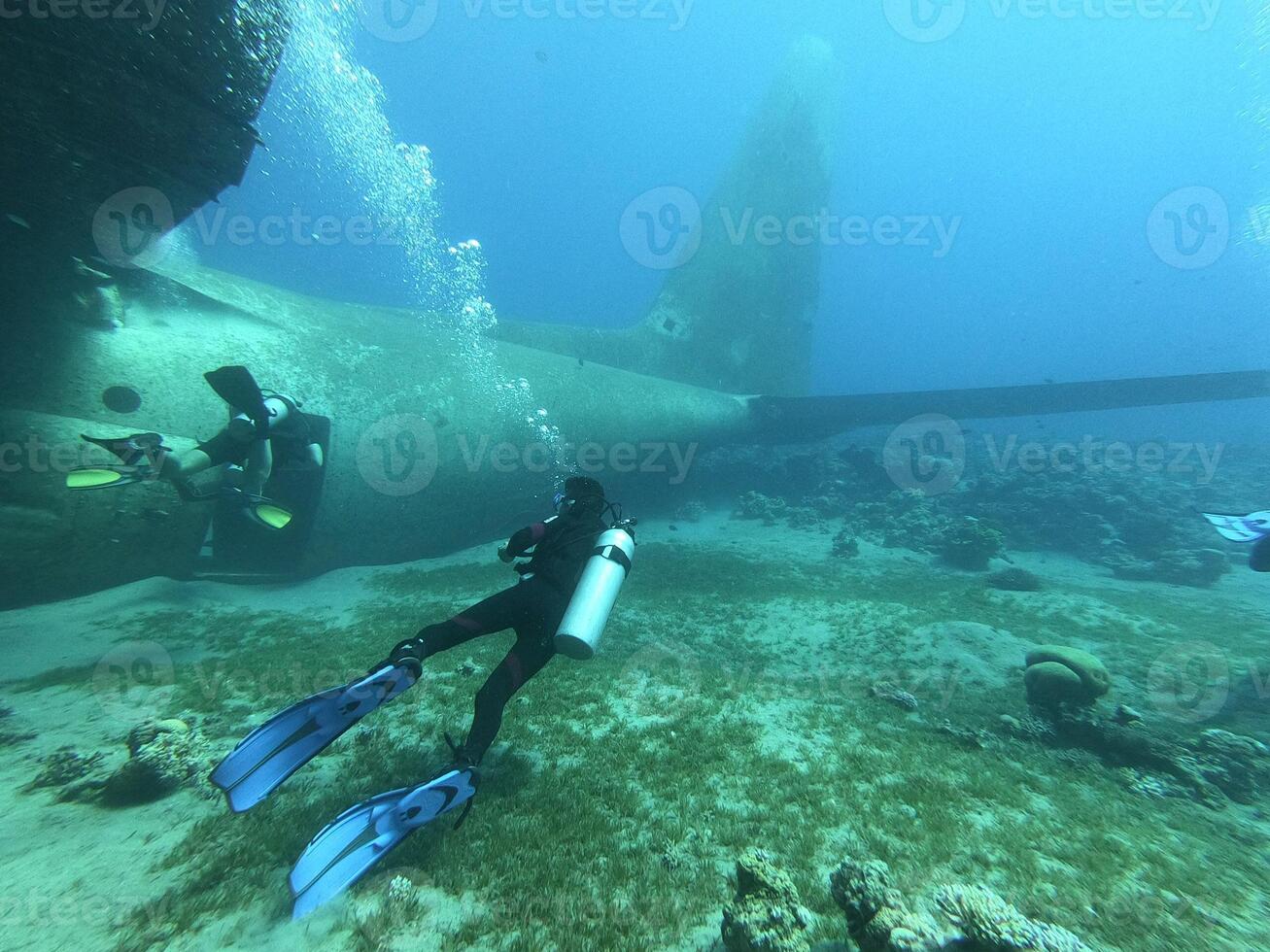 The Underwater Exploration showcases divers bravely exploring an intriguing sunken aircraft photo