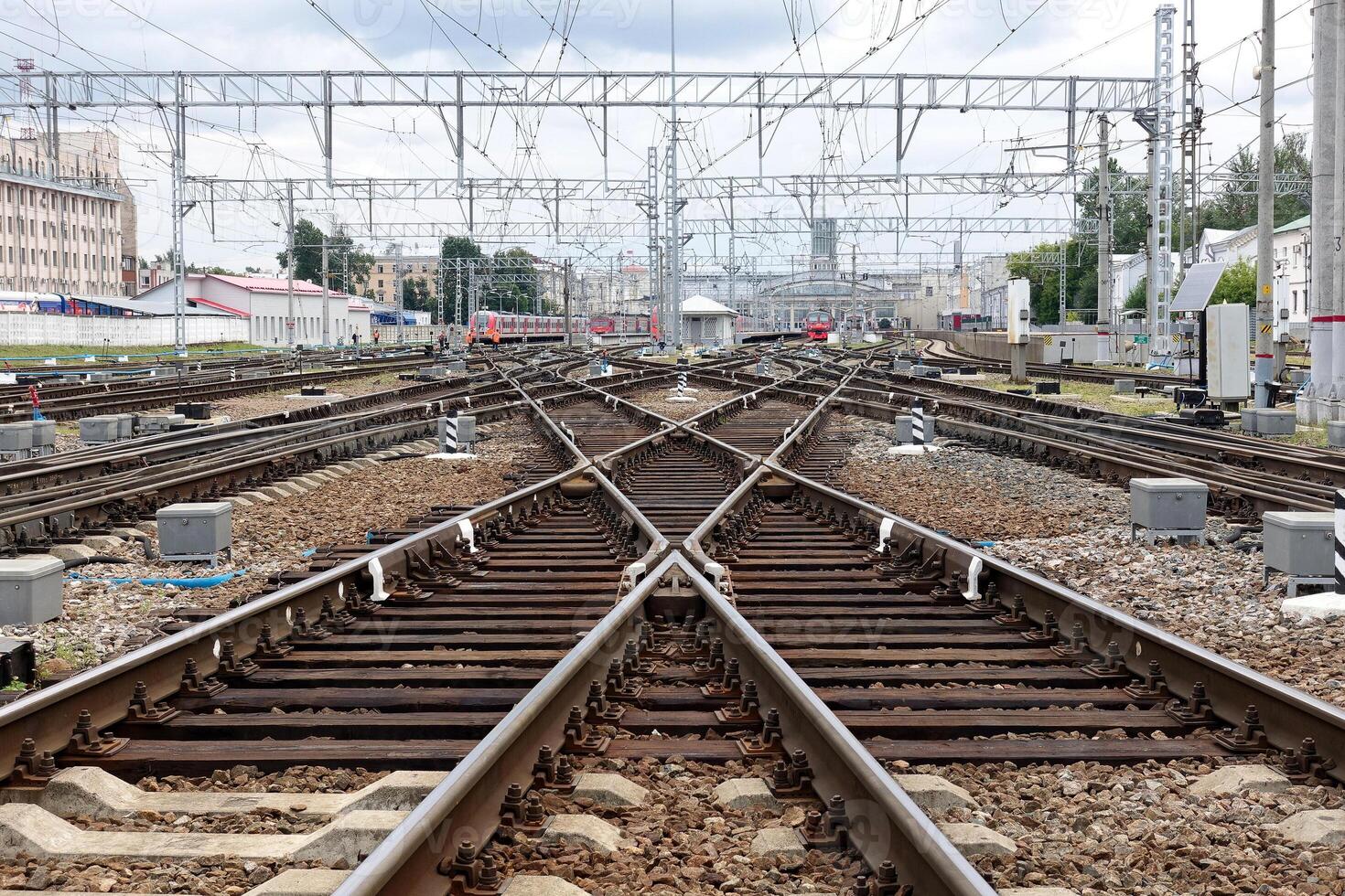 The captivating view of railroad tracks converging at a bustling and busy train junction photo