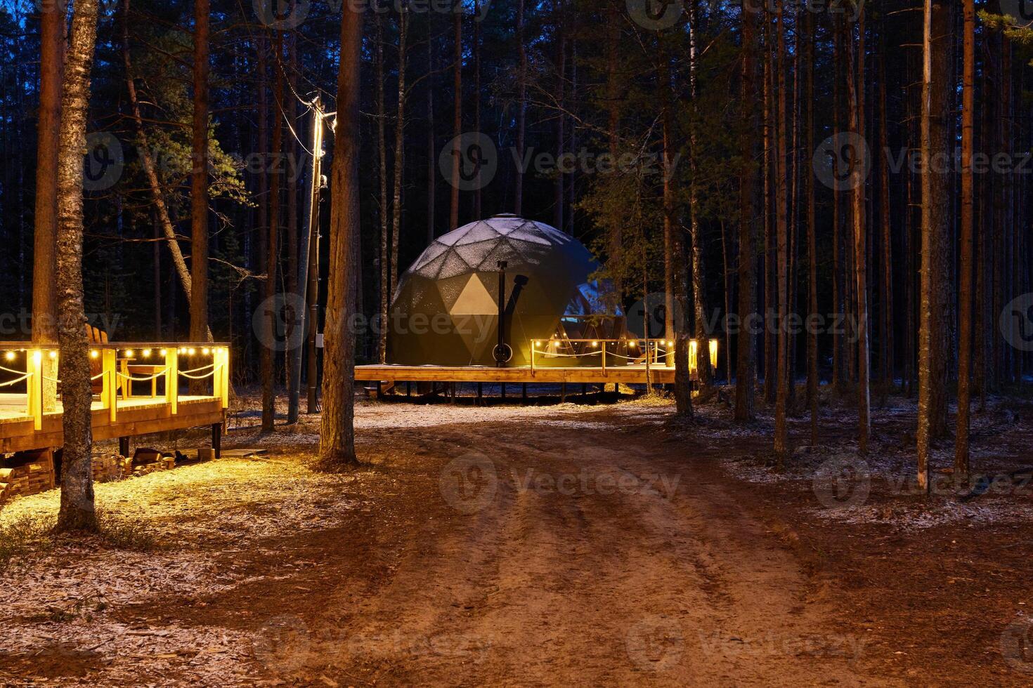 A Serene Dome Structure Nestled in a Lush Forest During the Beautiful Twilight Hours photo