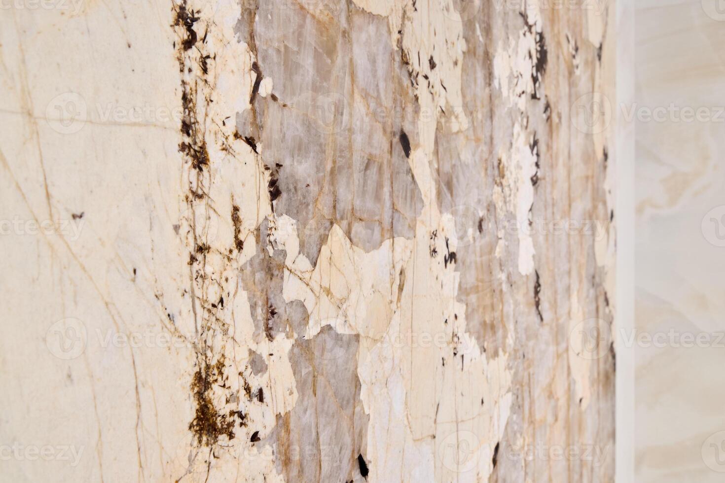 A textured wall with peeling layers reveals an interesting surface beneath, adding depth photo