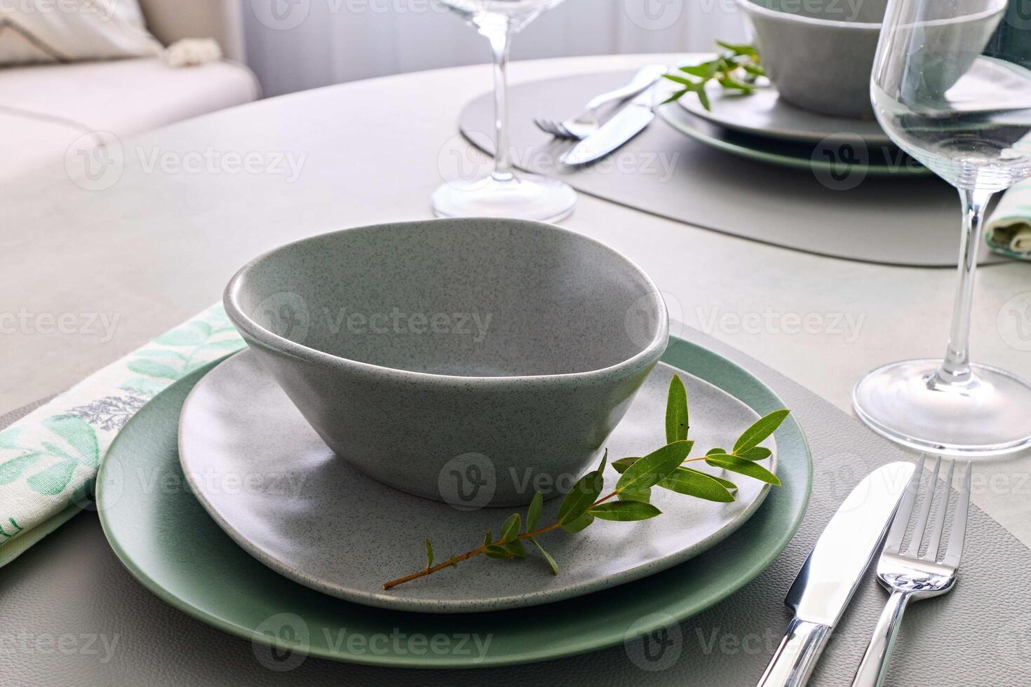 An Elegant Table Setting with Trendy Dishware, Beautiful Greenery, and Artful Touches photo