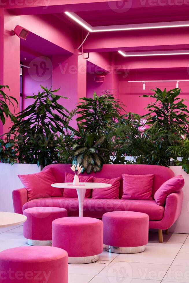 Experience the Pink Lounge with Modern Decor and lush Greenery for a delightful ambiance photo